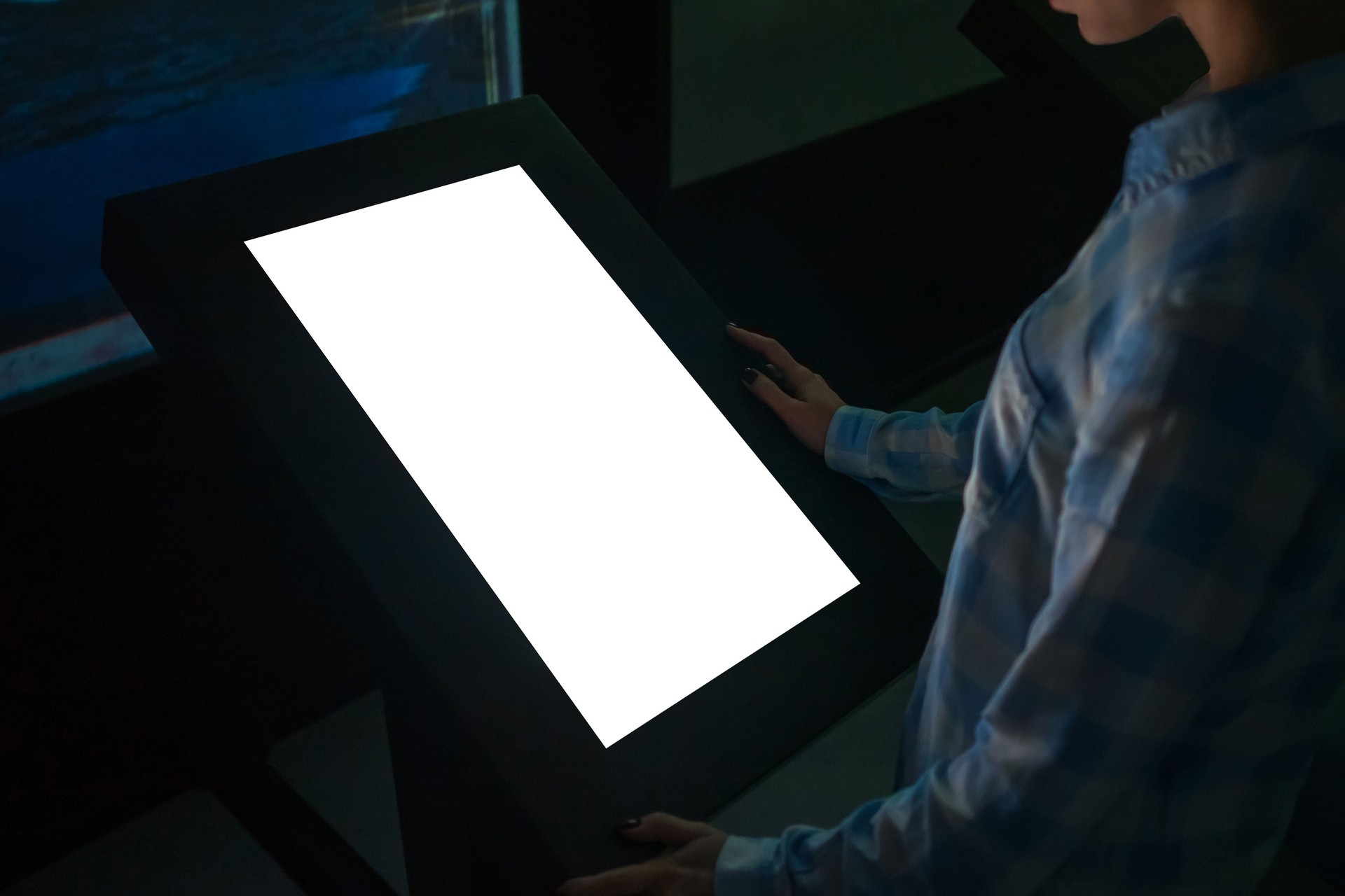 Mockup image - woman looking at white blank touchscreen display kiosk